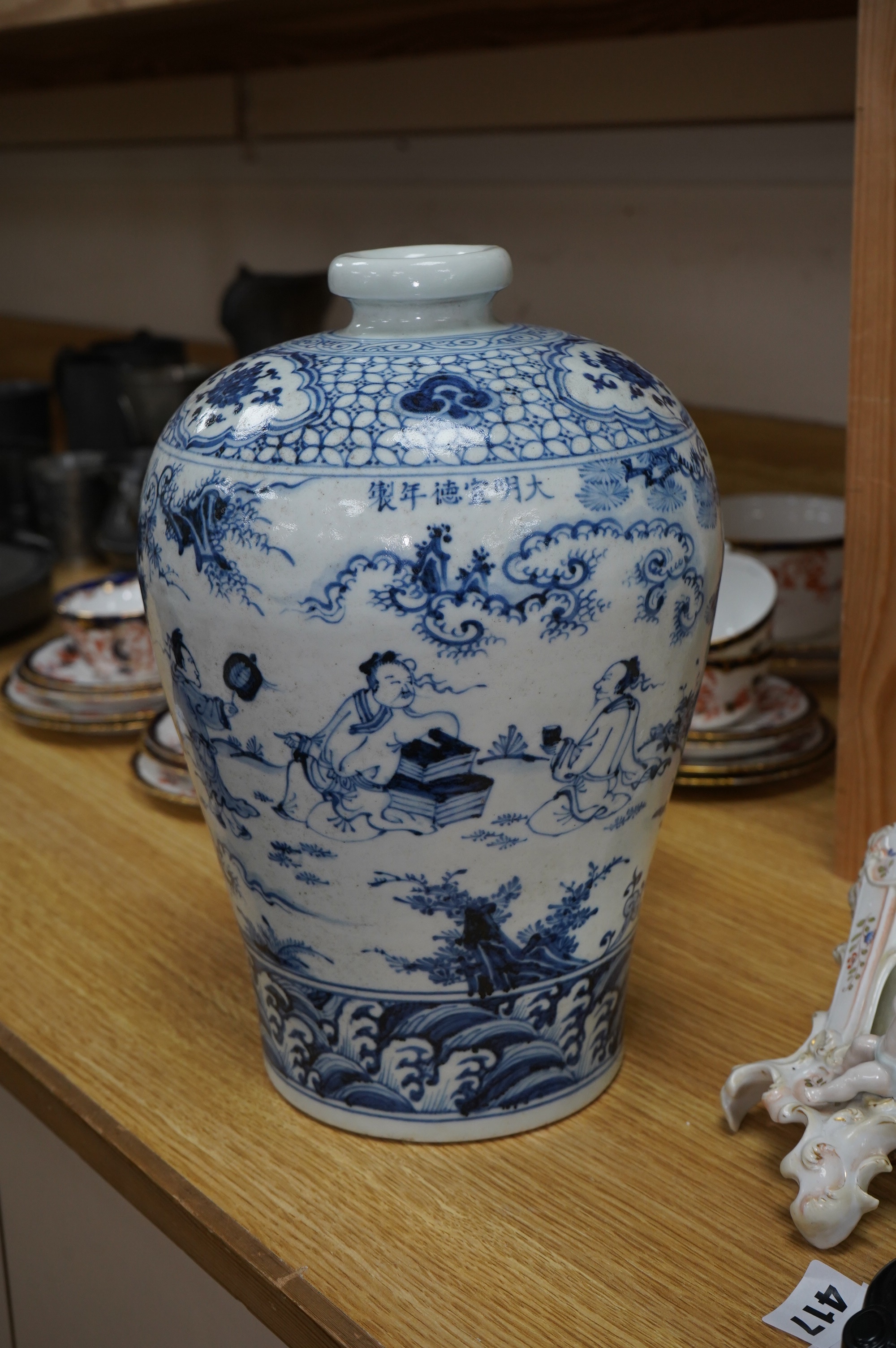 A Chinese blue and white vase, decorated with figures before a landscape, 31cm high. Condition - good